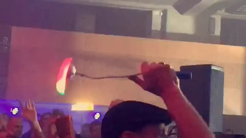 Music guy moving neon light in circles