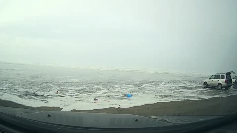 Family Surprised by Incoming Waves at Their Car at the Beach. Run.
