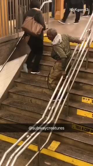 Guy on stairs green jacket trying to walk down slowly