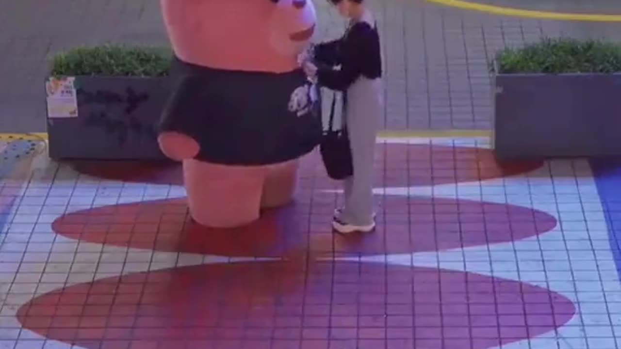 woman huged huge teddy bear in markete