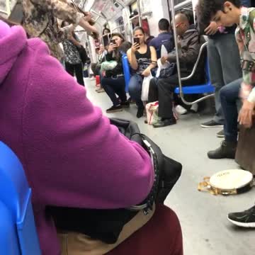 Violin and drums played by two people on train