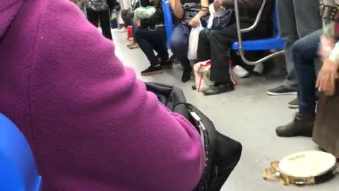 Violin and drums played by two people on train