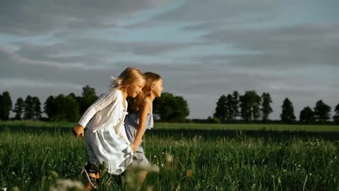 GIRLS RUNNING IN FIELD