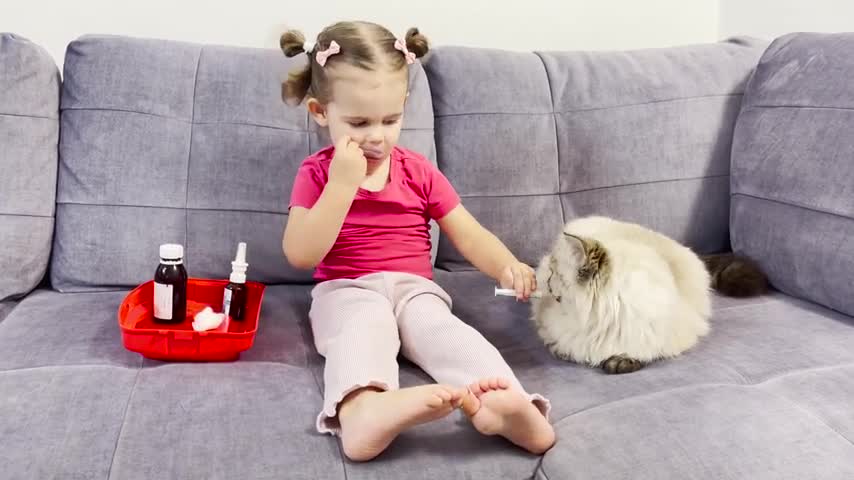 Baby_Girl_Provides_Vet_Care_to_Fluffy_Cat_