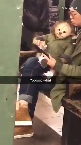 Girl in green jacket on phone with dog animal doll in green jacket on her lap