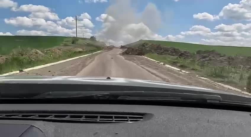 Ukrainian soldiers drive away under fire