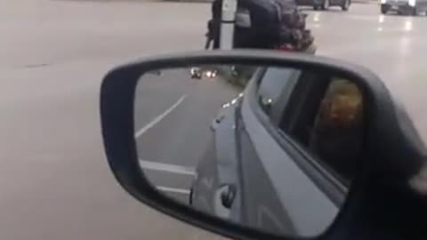 Elderly Woman Scooters on Road