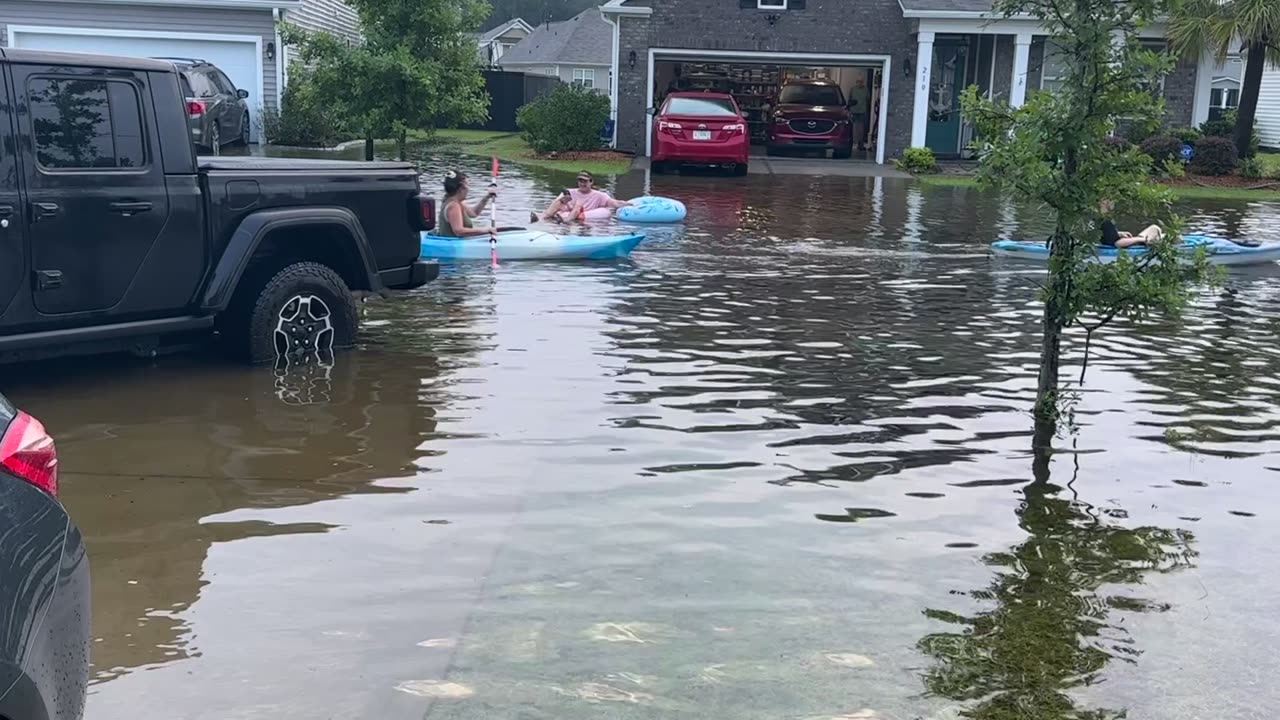 Neighbors Make the Most of Flooded Street