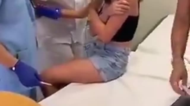 Young Girl Getting Jabbed Against Her Will, Every Single one of These Bastards Need to Be Hanged.