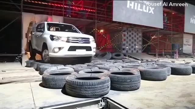 Pickup trucks are displayed over tires