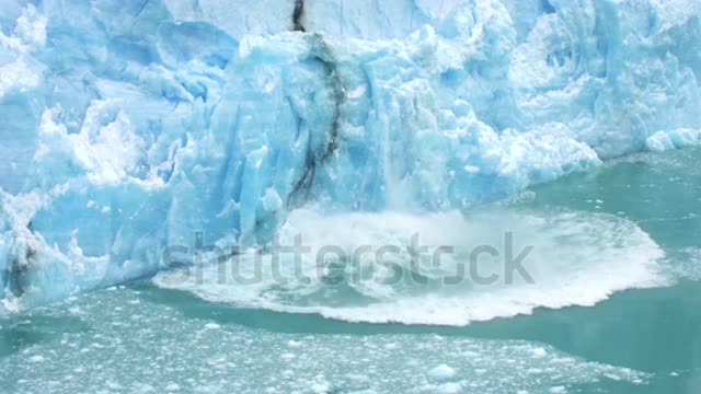 Glacier Ice Collapse Into Ocean Water, Close Up. Global Warming and Climate Change Concept
