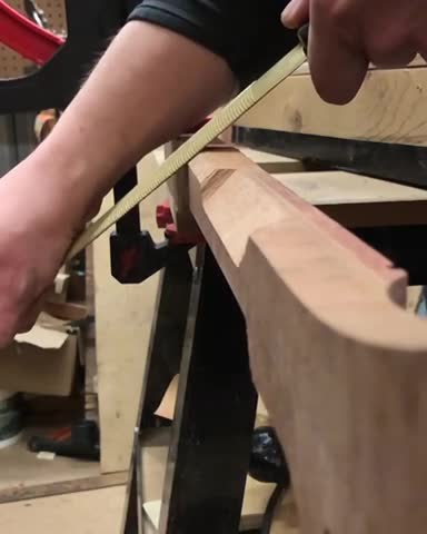 Shaping a guitar neck.
