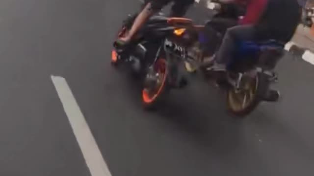 Standing motorcycle crashes into a car