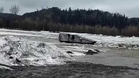 People stranded on a flooded bridge