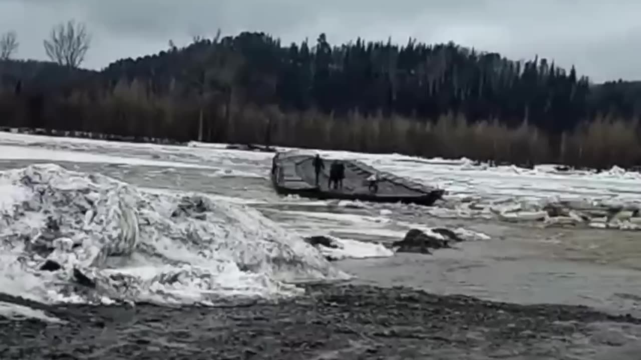 People stranded on a flooded bridge