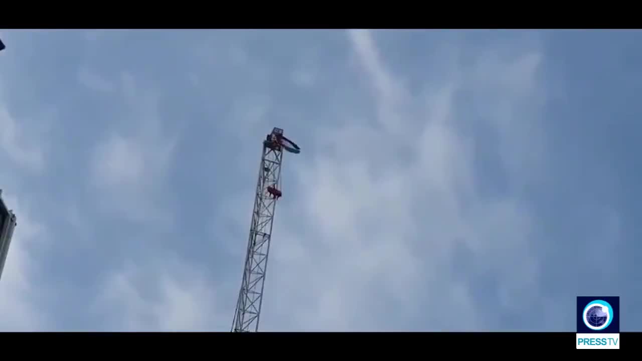 An activist climbs up crane in central London to protest Israeli atrocities against Palestinians!