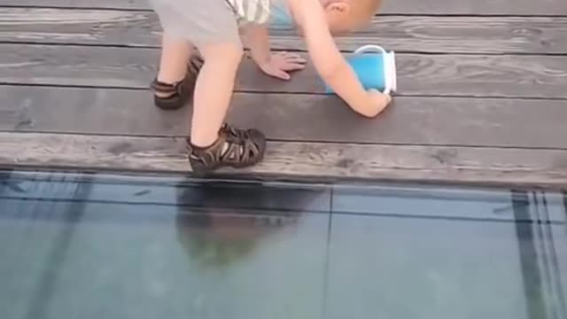 Toddler tries to walk on glass