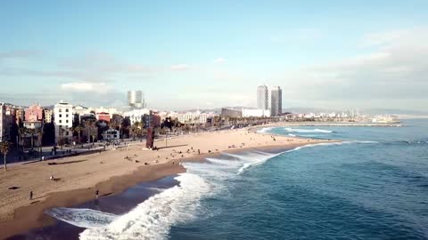 Large waves breaking along a city beach