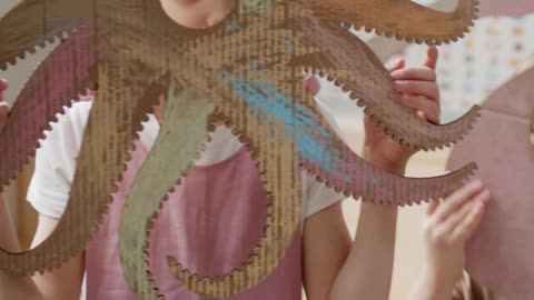 children-covering-their-faces-with-cardboard-animals