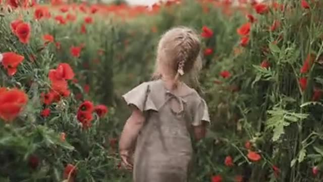 A beautiful girl walking in the wonderful orchard