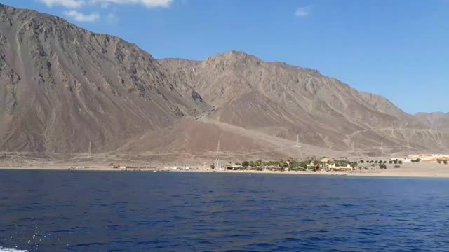 Speedboat walking near hills