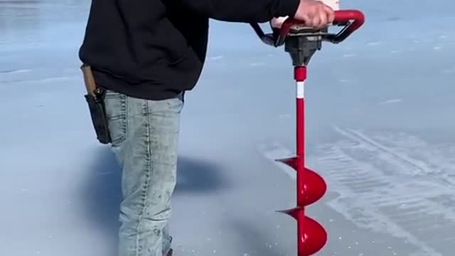 Man Drilling on the Snow Ground for the Fishing