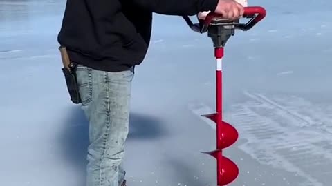 Man Drilling on the Snow Ground for the Fishing
