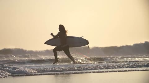 Surfer Running Along a Beach