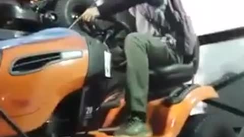 Guy lawnmower on rack jumps off fail