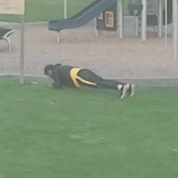 Guy doing planks pushups pelvic thrusting grass playground