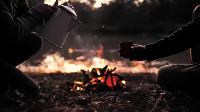 The Secret of Successful PEOPLE POURING A WARM DRINK AROUND A CAMPFIRE