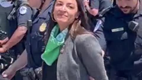 Why is AOC Pretending to be Handcuffed?