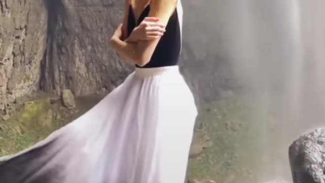 The girl is dancing in Waterfull