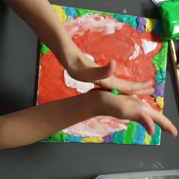 daughter draws with plasticine