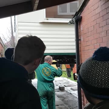 Static caravan being craned into position 1