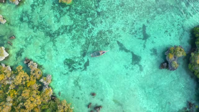 Drone capture Magnificent footage of boat in a blue sea