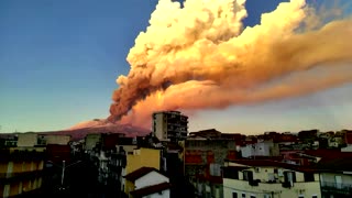 Mount Etna fills the Italian sky with orange smoke