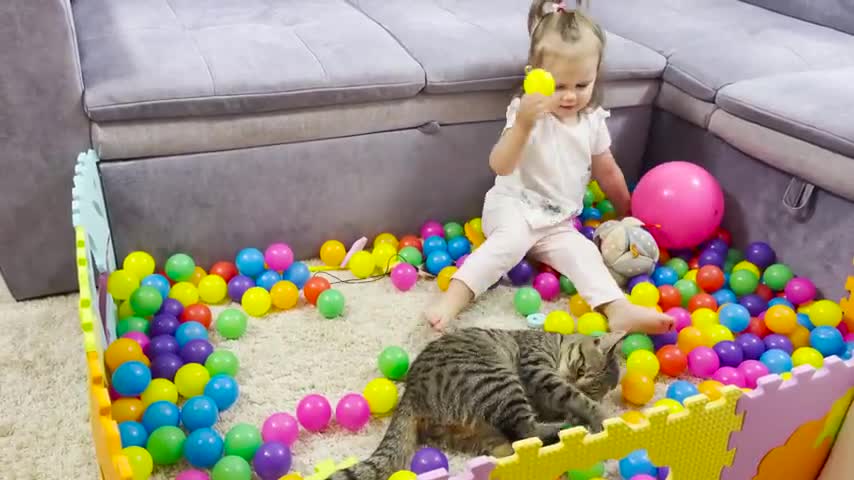 Cute_Baby_and_Funny_Cat_Playing_in_a_Ball_Pit