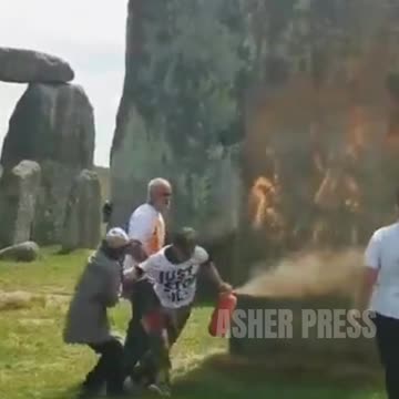 Eco activists DESECRATE 5,000 year old Stonehenge, spraying it with orange substance.