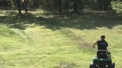 Guy mowing grass gets beer tossed at him and drinks it