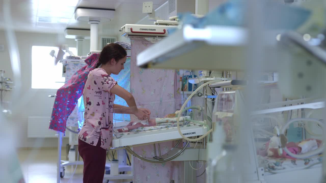 nurse doing some medicine to the small baby