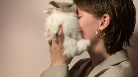 woman-holding-a-rabbit-close-to-her-face