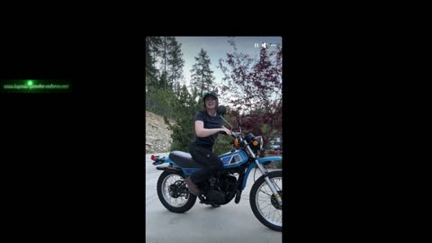 A woman starts a 1977 Yamaha DT250D