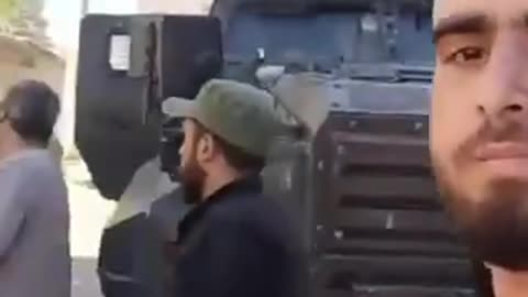 Syrians control Turkish army armored vehicles.