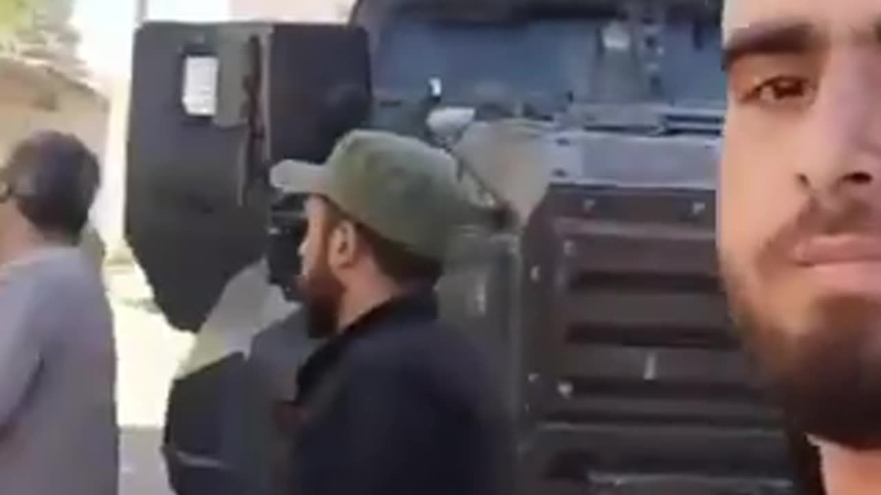 Syrians control Turkish army armored vehicles.