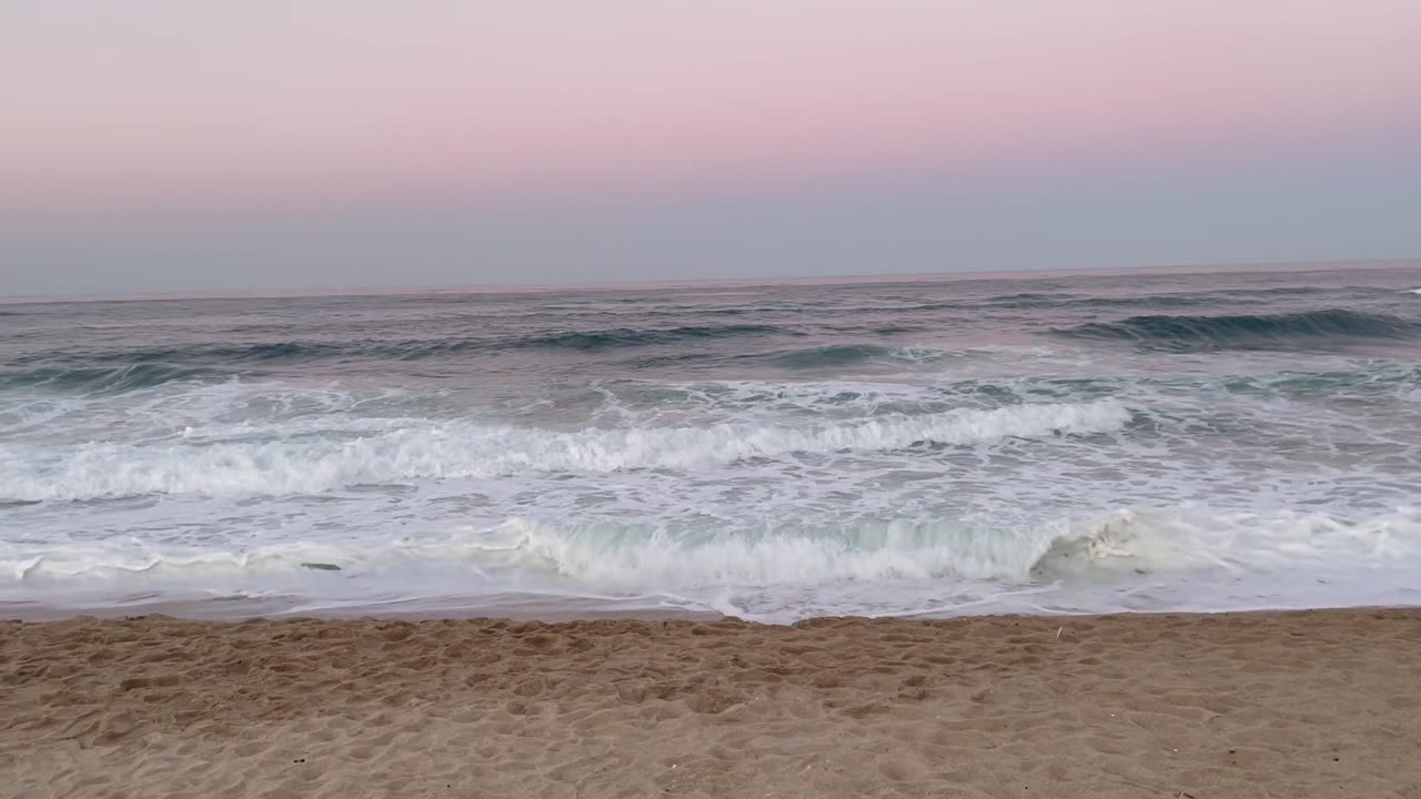 Pink sky and blue sea