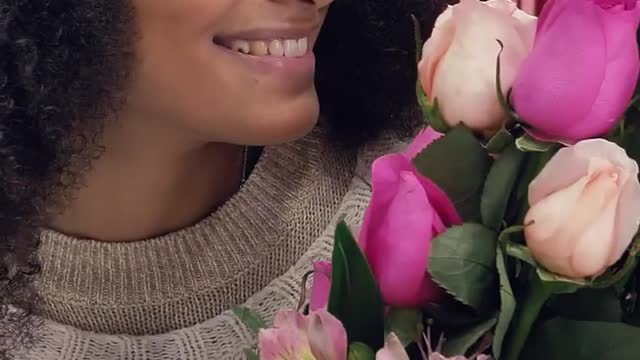 Young delighted woman with bouquet of flowers on Valentine&#39;s Day