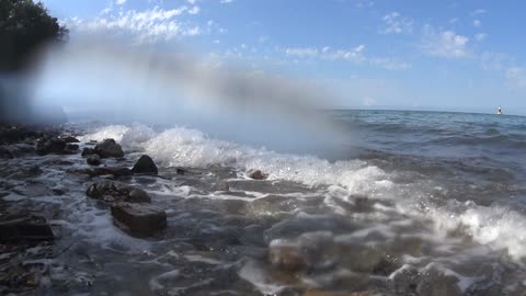 Waves of salty water hitting stones.