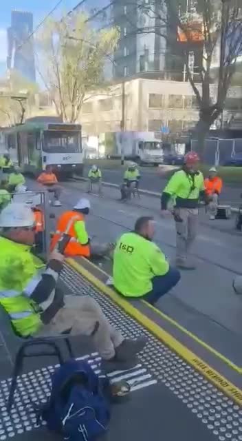 Construction workers stage sit in to protest vaccine mandates in Australia