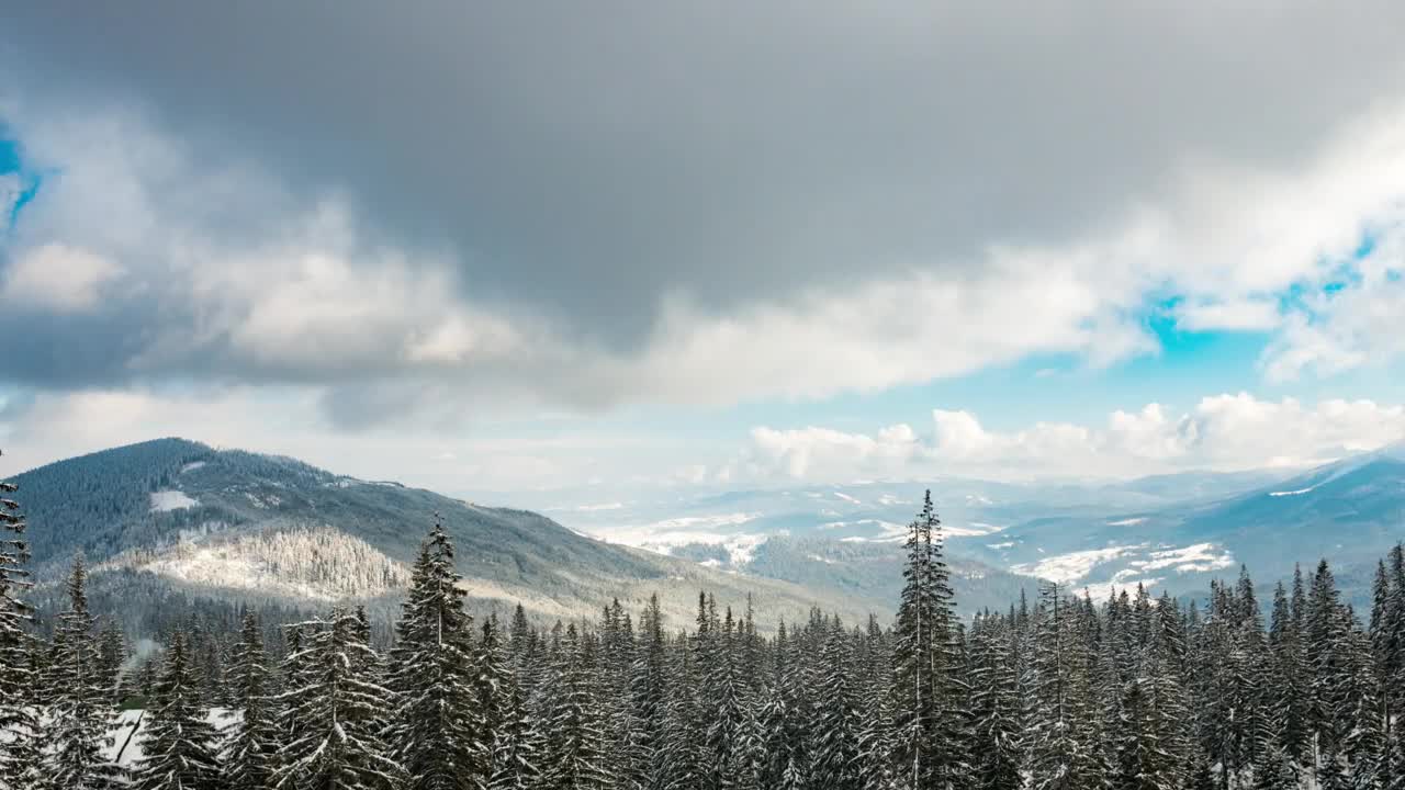 Moving clouds over a snowy wooded landscape